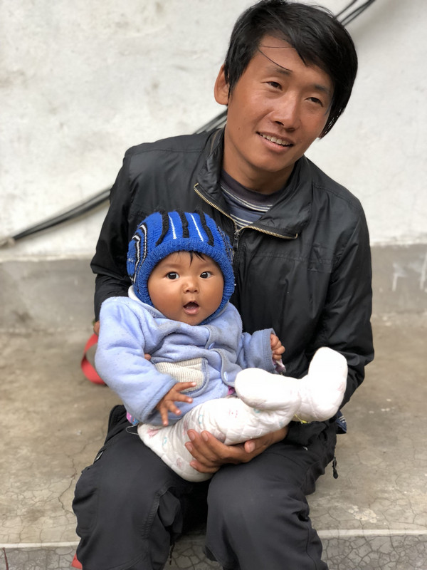 Himal (guide) holding tea house owners baby