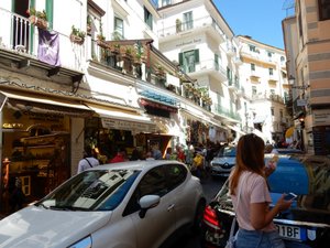 Narrow street, large cars mixing with pedestrias at Amalfi