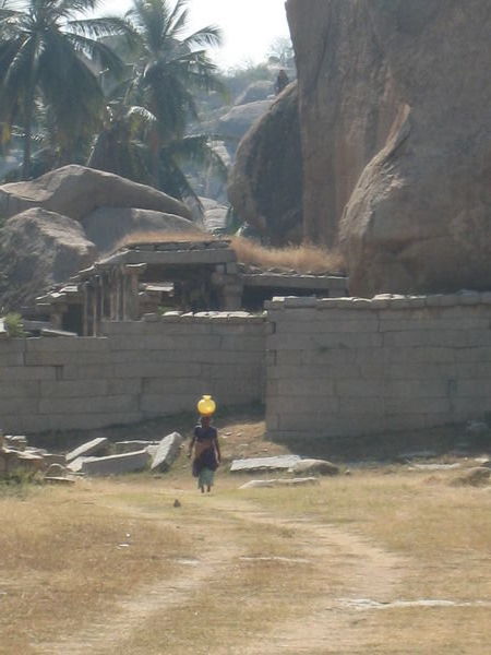woman carrying water to workers
