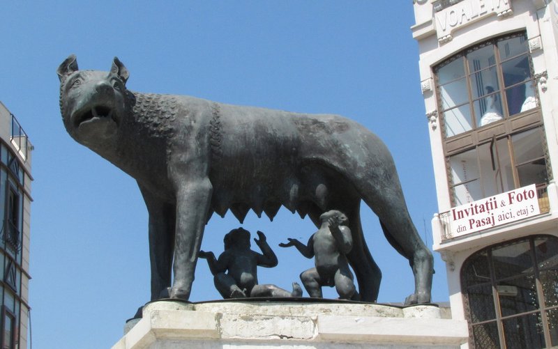 Romulus and Remus suckle beneath the wolf.