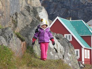 Little Inuit girl playing on the hill