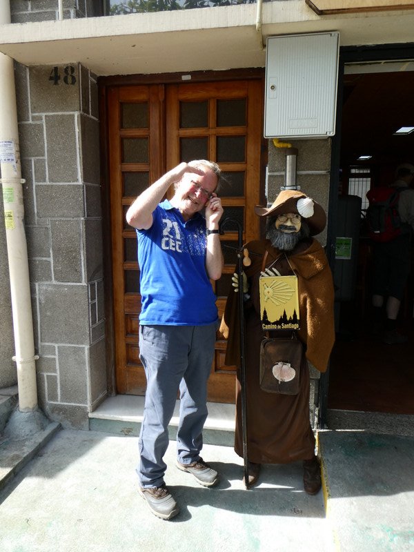 A scruffy pilgrim and some statue outside a cafe!