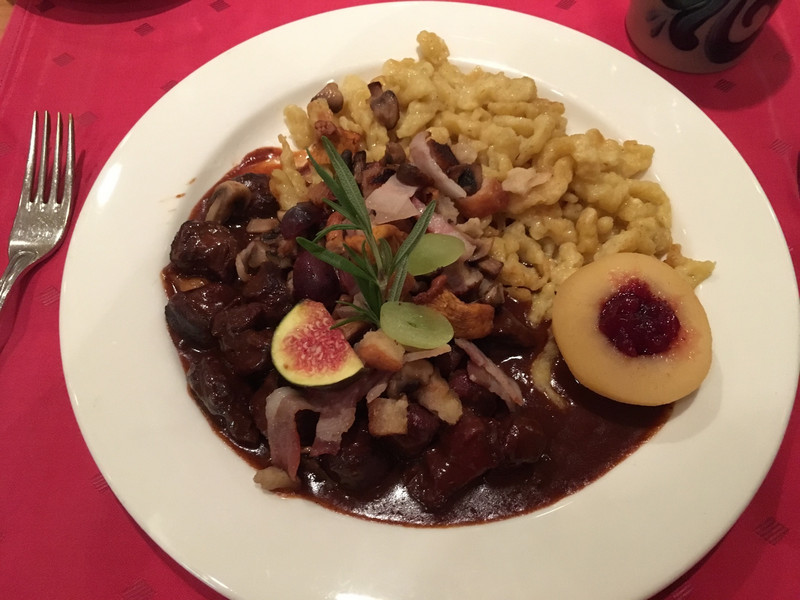 Venison, spaetzle (dumplings) with small bits of bacon, slice of fig, mushrooms, warmed pear with cinnamon