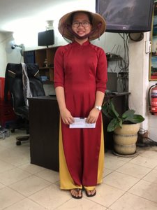 Travel agent wearing ao dai - traditional Vietnamese clothing