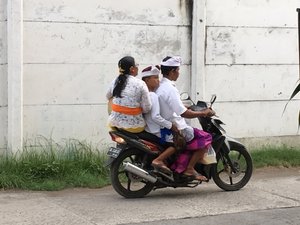 Going to temple on overcrowded motorbike