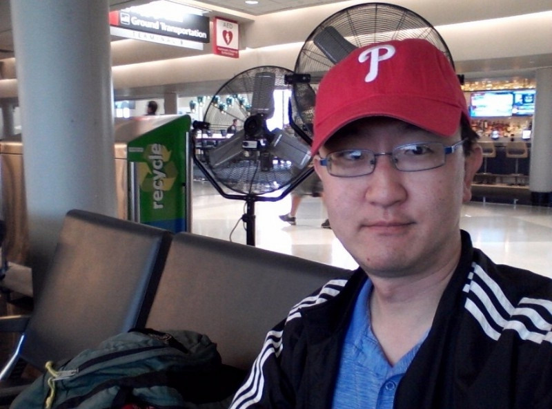 me wearing a Phillies cap at airport