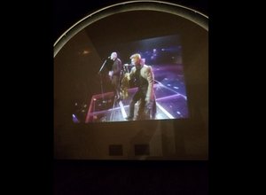 Bowie concert playing in theater