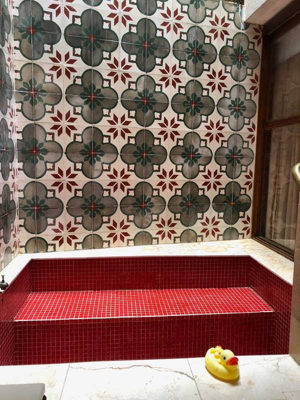 a tiled bath tub with rubber ducky