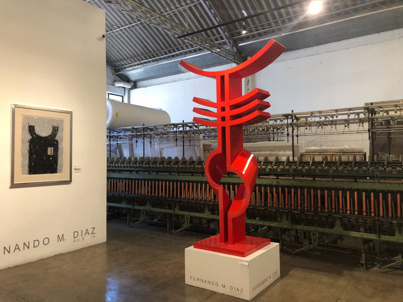 a sculpture in front of spinning machine