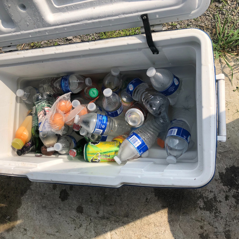 Ice chest with a variety of drinks.