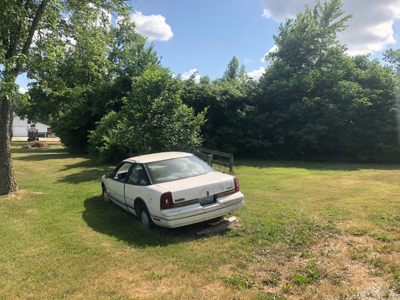 This abandoned car was sitting next to the abandoned house.