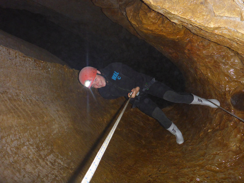 Casually abseiling into a deep black cave
