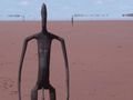 Antony Gormley's installation (that's a mirage not water in background)