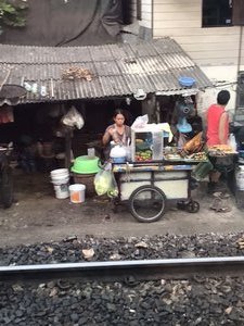 Street vendor beside the train tracks in Bangkok 