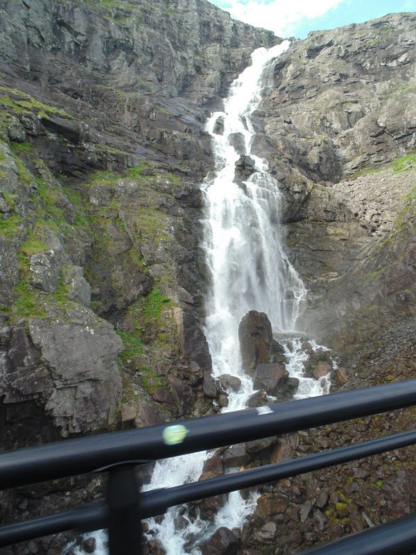 Waterfall goes under road on Trollstigen