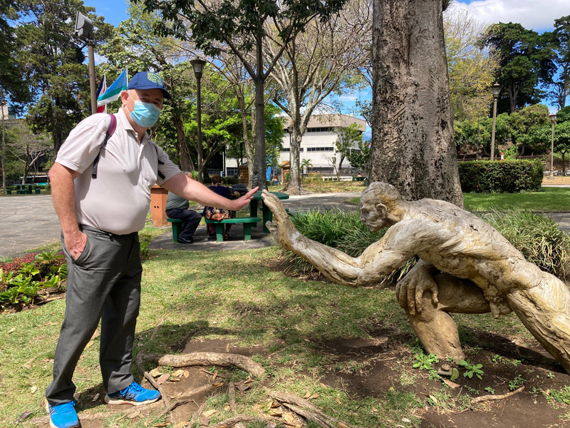 Old man high fives well endowed sculpture 