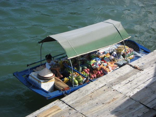 Boy selling fruit in the bay.