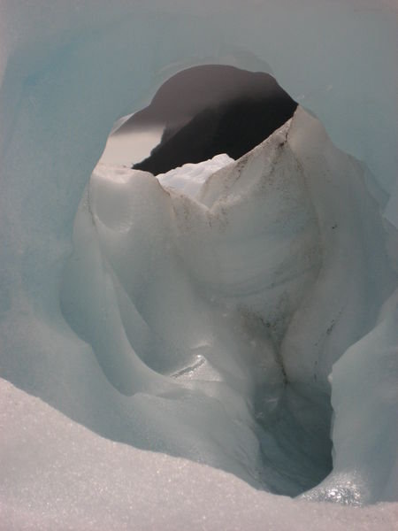 a view of the mountains through the ice hole...