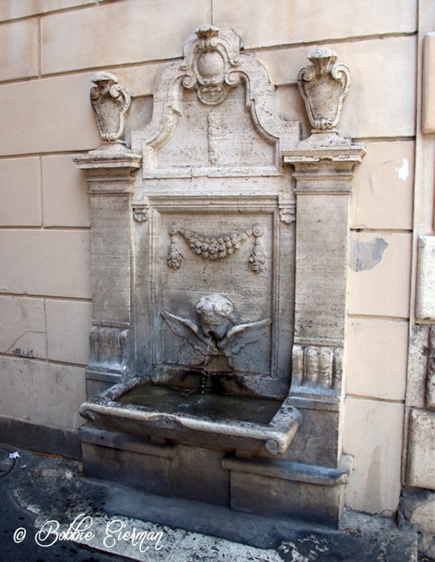 Roman water fountain on the street