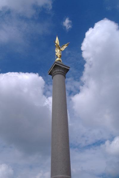 some hugh war memorial with a gold statue on top