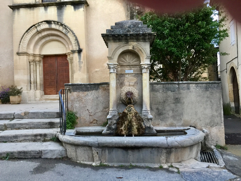 Ancient fountain in front of the village church