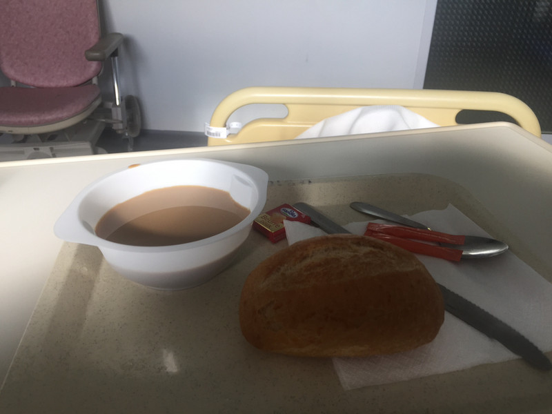 Breakfast - a bread roll and bowl of coffee