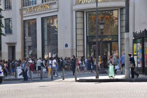 Keen shoppers waiting to visit the Louis Vuitton store