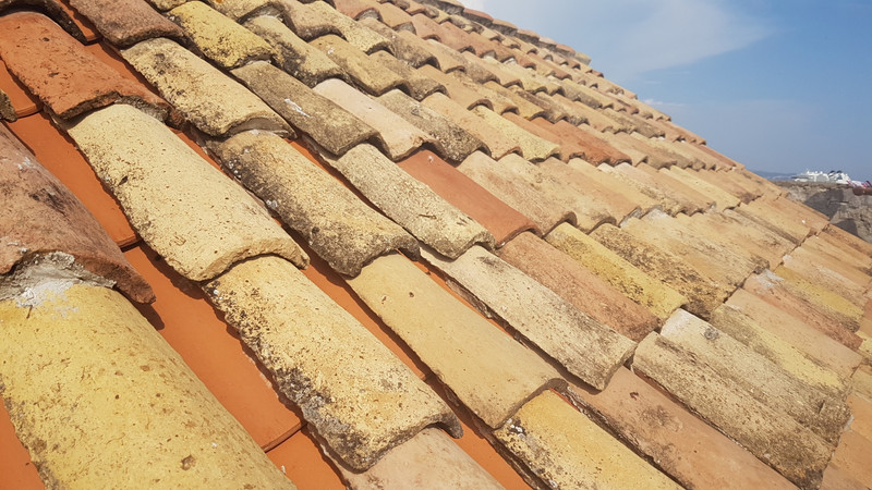 Old roof tiles over new ones, to preserve the look 