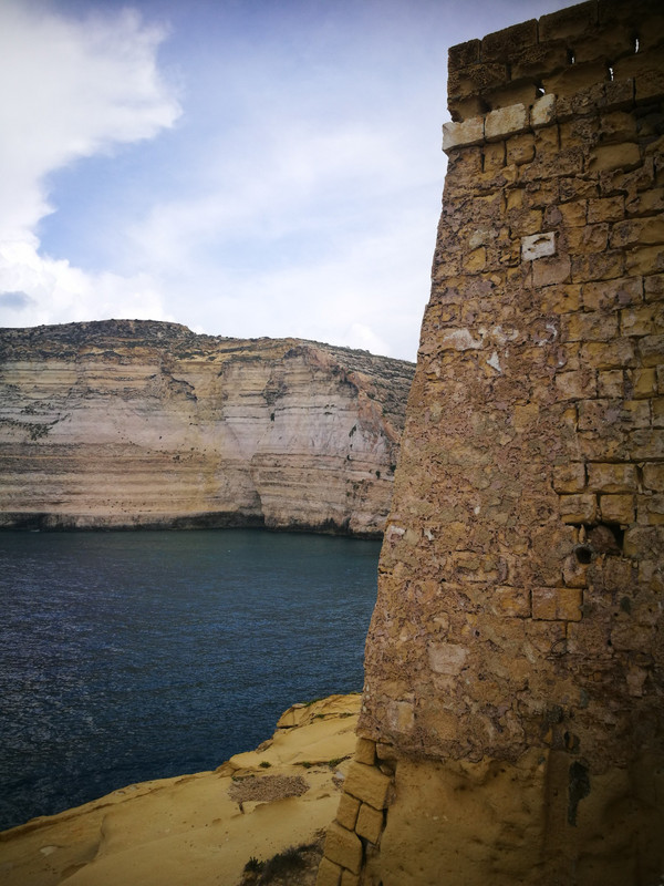 Xlendi Tower and cliffs beyond 