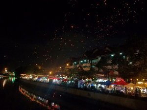Lanterns above, street party in the middle and floating candles down below