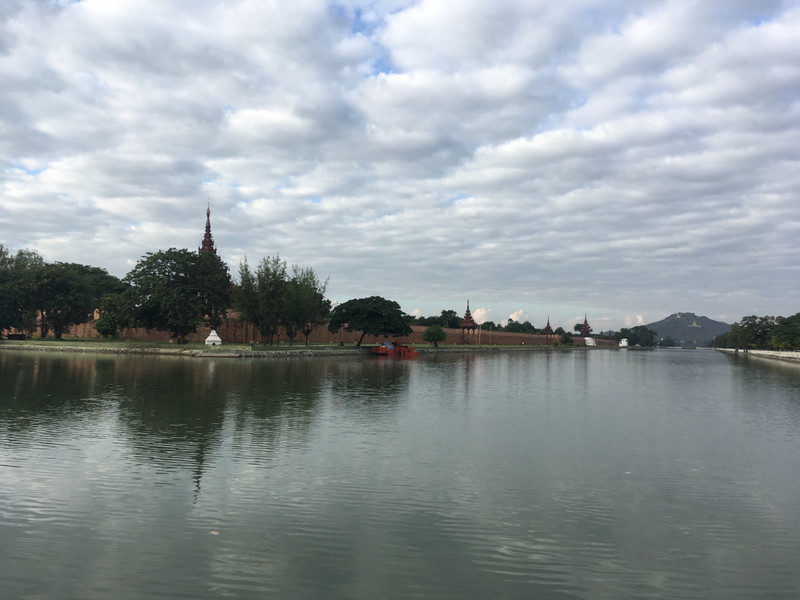 Moat around palace and Mandalay Hill in distance
