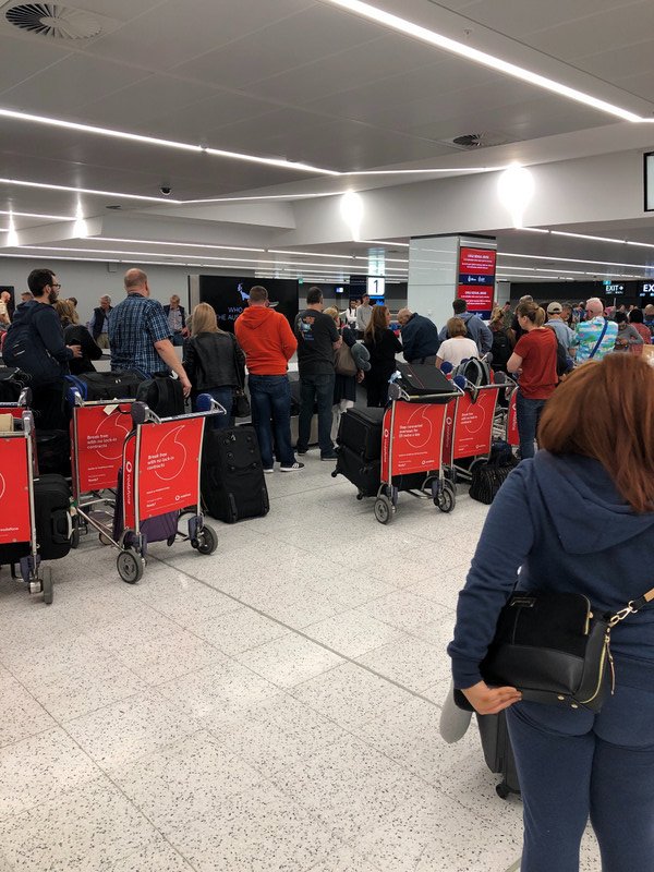 The scrum for luggage at the carousel in Sydney