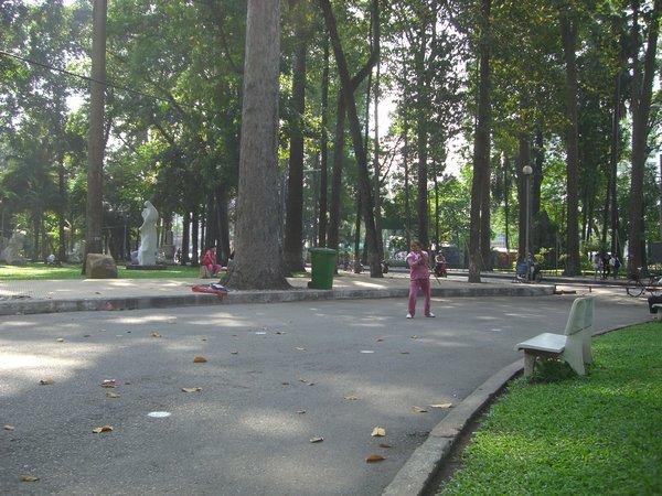 A woman practicing martial arts in the park