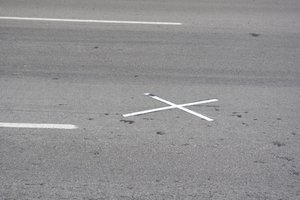 The cross represent the exact spot where JFK was shot...