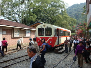 Passengers alighting from the Alishan Forest Railway to walk to another segment of the rail tracks to continue their journey