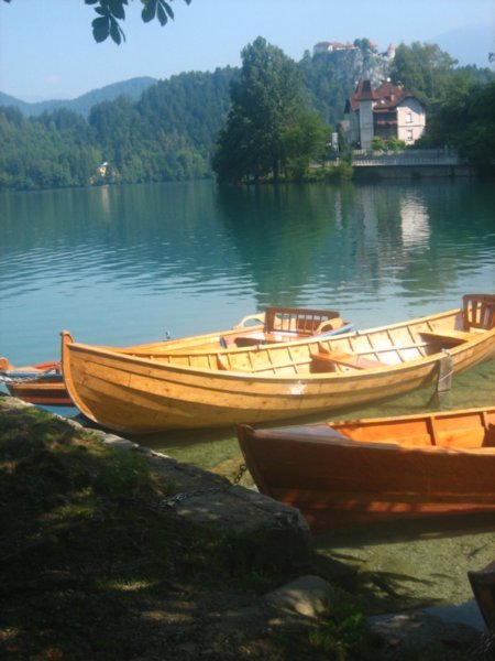 Boats on the lake and castle on the hill in the background