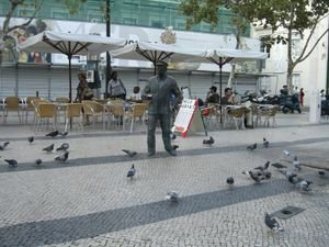 Statue and pigeons in small plaza