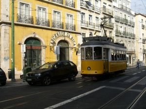 Tram passing by Elevador da Bica