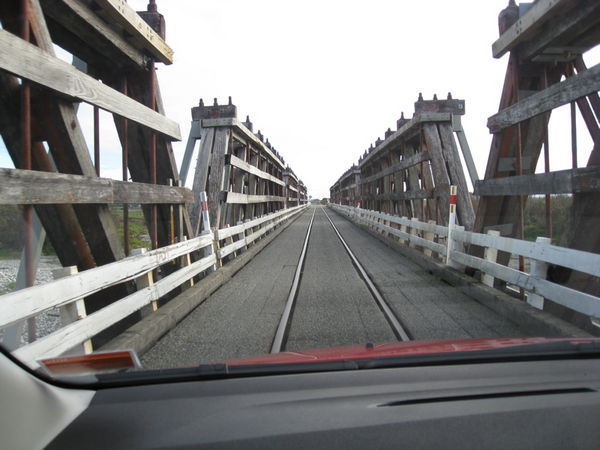 One lane bridge shared with a train.