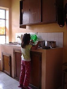 little girl getting herself soup for lunch
