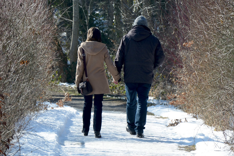 Couple walking in a winter forest