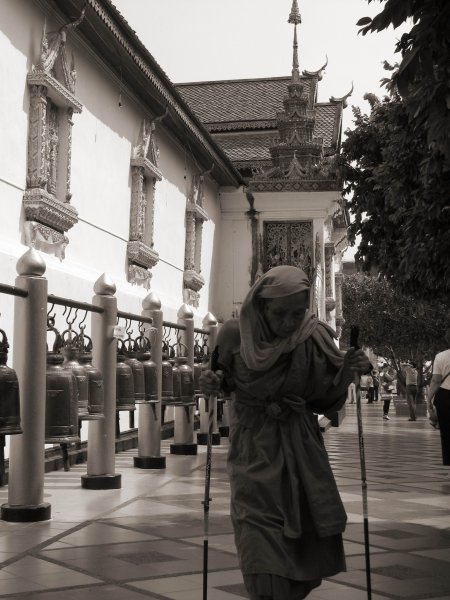 This monk appeared to walk around the wall of Golden Chedi. I caught a photo of him before but only his back could be seen.