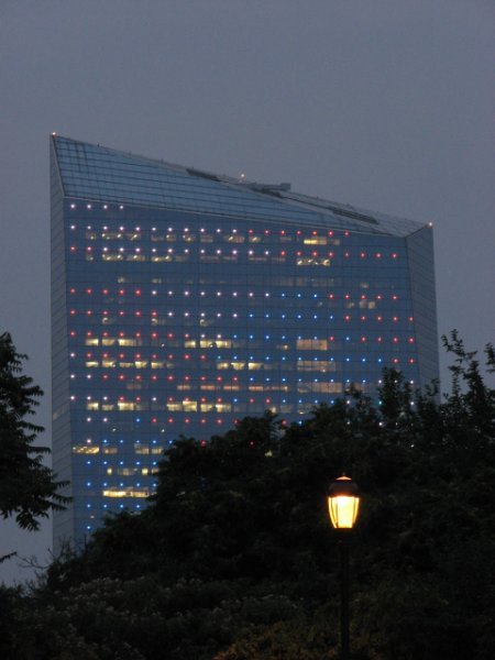 red, white,and blue lights lit on this tall skyscraper.