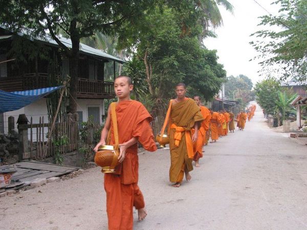 Buddhist monks lining up for their daily ritual.