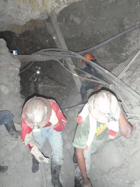 Miners working in harsh conditions.