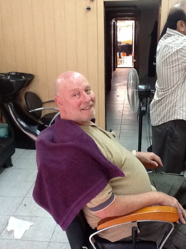 Looking a bit stunned in the barbers chair