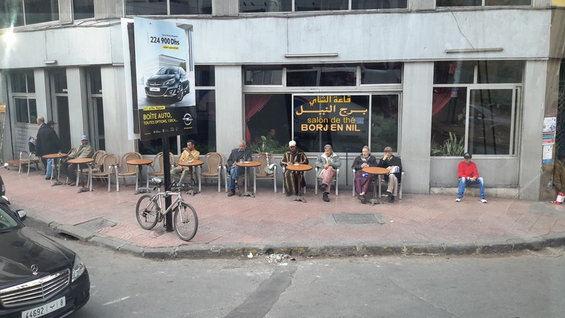 Typical street scene  Men outside of a coffee shop 