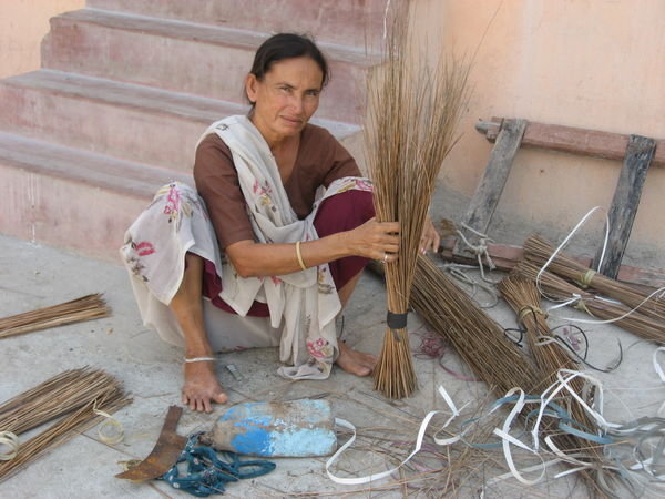 Woman making brooms