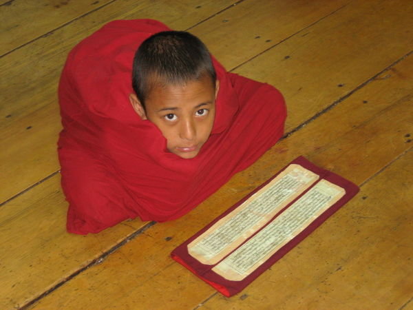 boy monk learning prayers