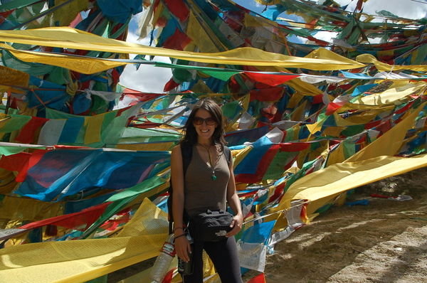 me in front of prayer flags at Ganden